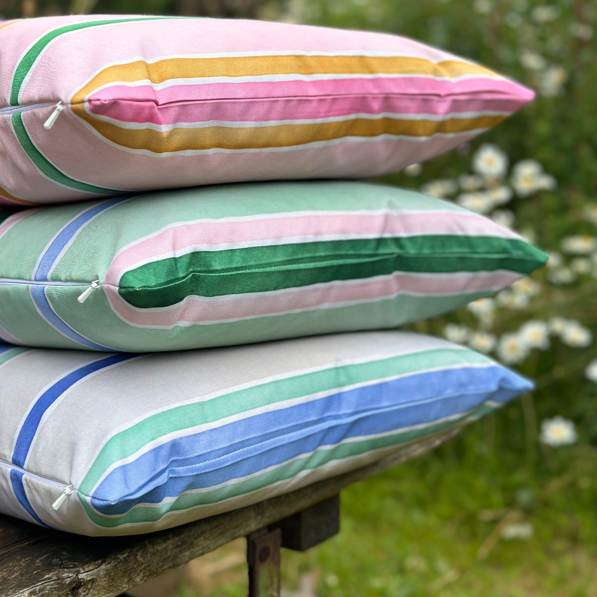 stacked outdoor cushions in garden